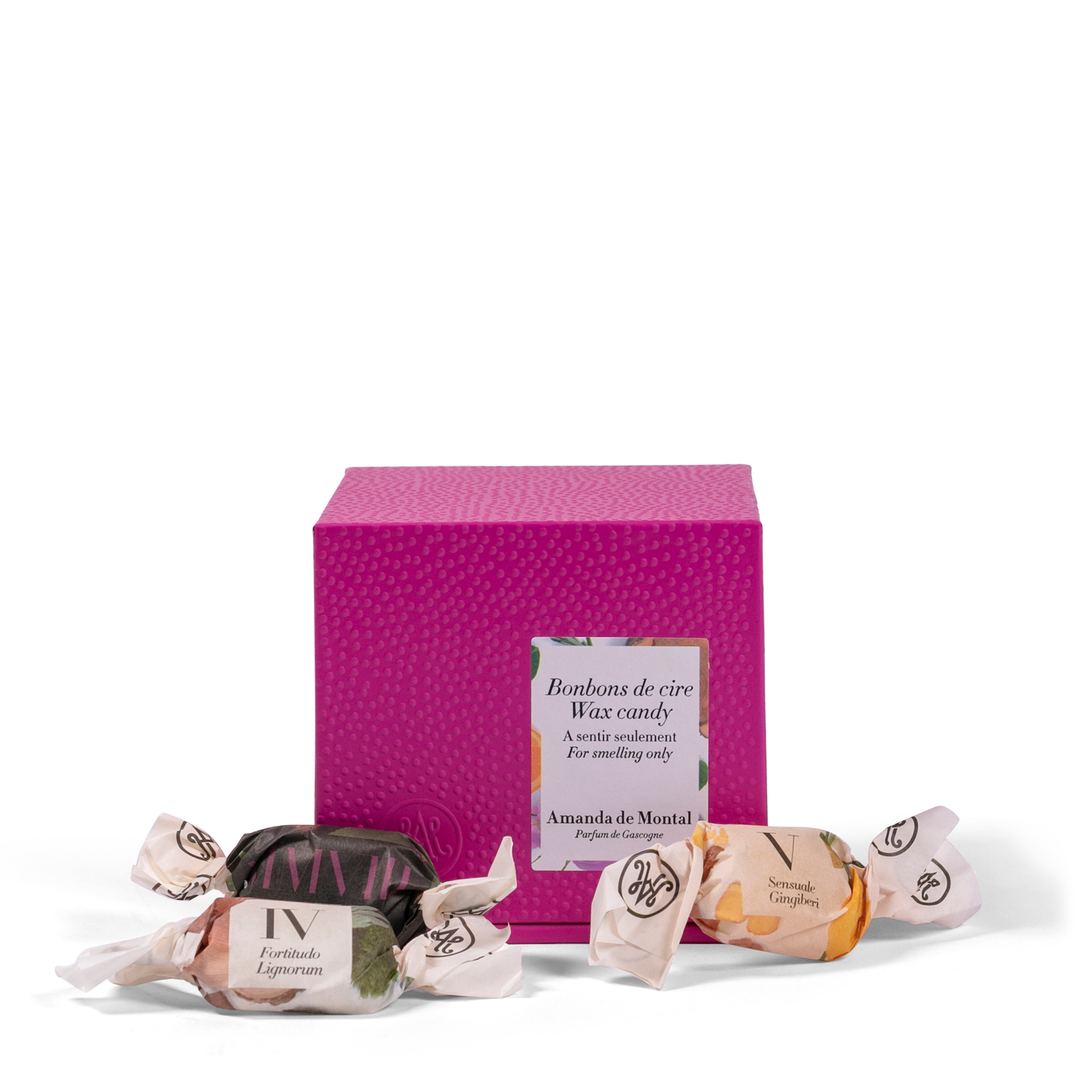 A small, elegant pink box containing a variety of perfumed wax candies. Each scented wax candy is crafted from natural, plant-based waxes, precisely blended to release delightful aromas. 