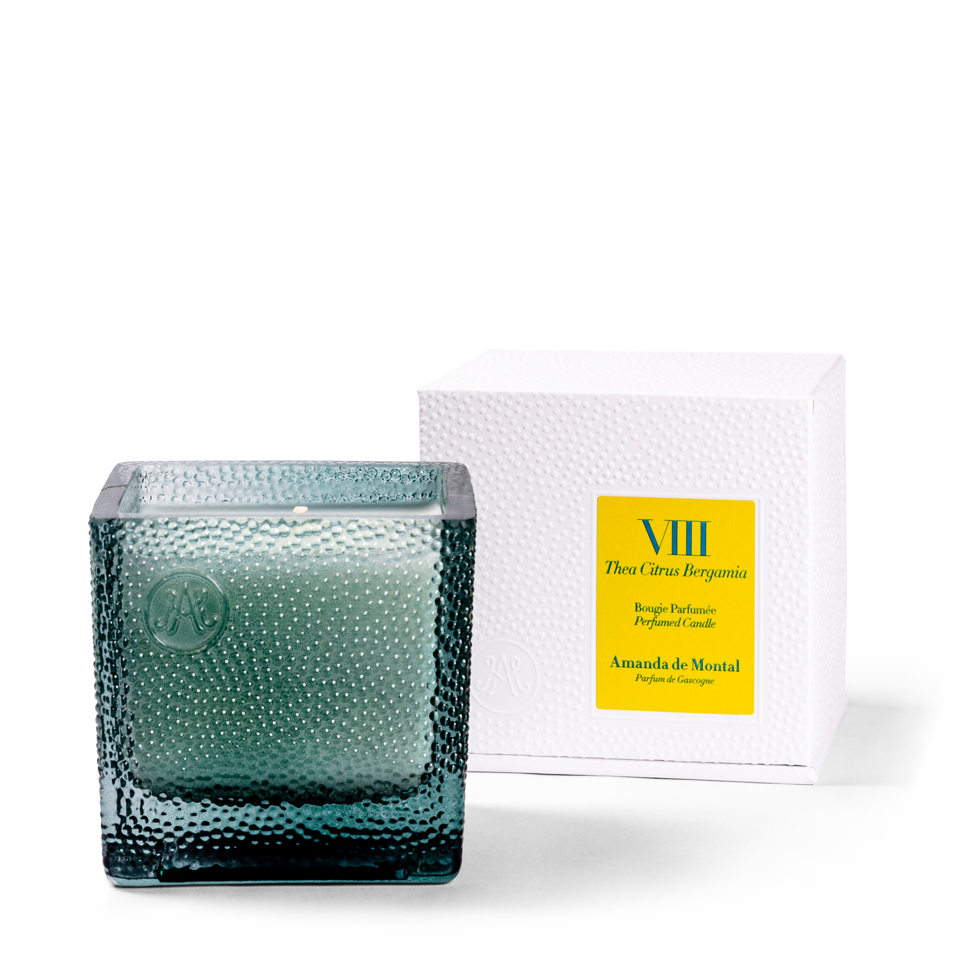 A candle with green tea scent complemented with hints of bergamot, evoking the taste of succulent local lemons in a lemon tart. Held in an artisanal blue glass vessel with thousands of bubbles and a twinkling flame.