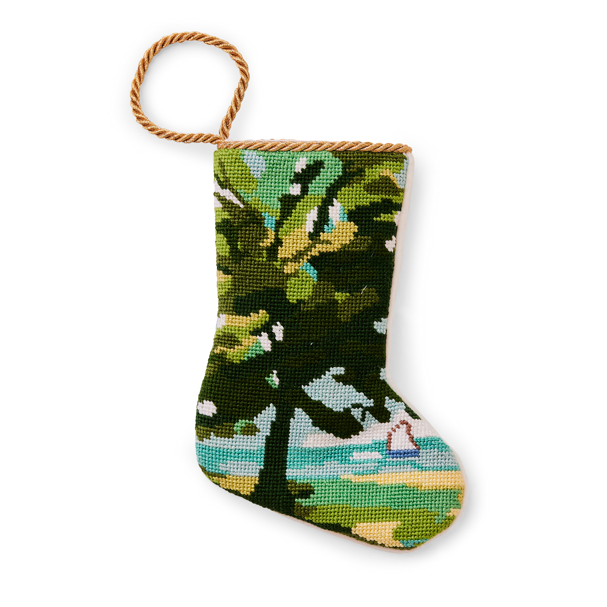 A small, intricately designed needlepoint stocking featuring a scene with tree and a sailboat on the sea in the distance. The background depicts a bright, summery setting. A gold loop at the top makes it perfect as a tree ornament, place setting, or for hanging by the fireplace.