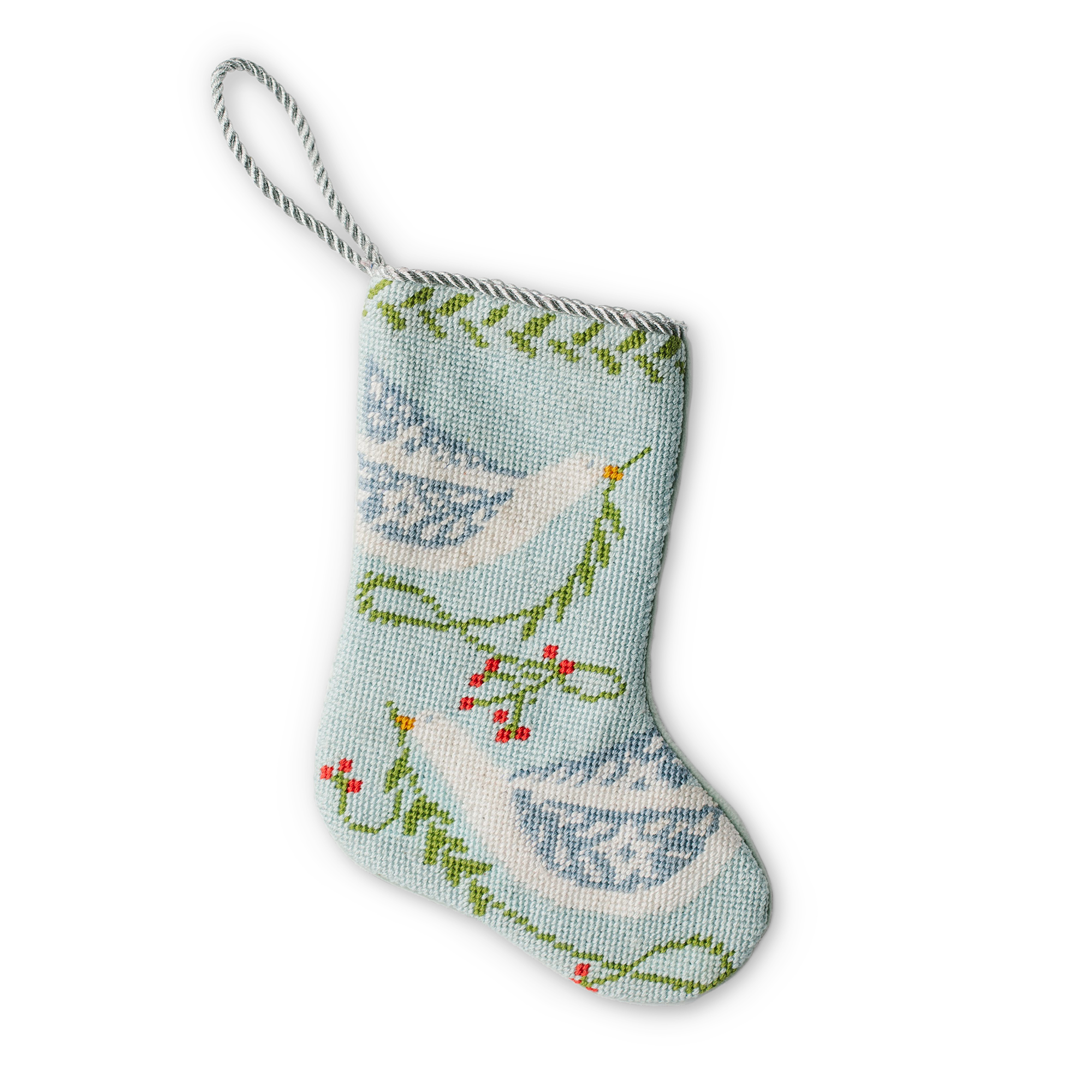 A small, intricately designed needlepoint stocking featuring an illustration of 2 doves carrying branches, set against a light blue background. A gold loop at the top makes it perfect as a tree ornament, place setting, or for hanging by the fireplace.