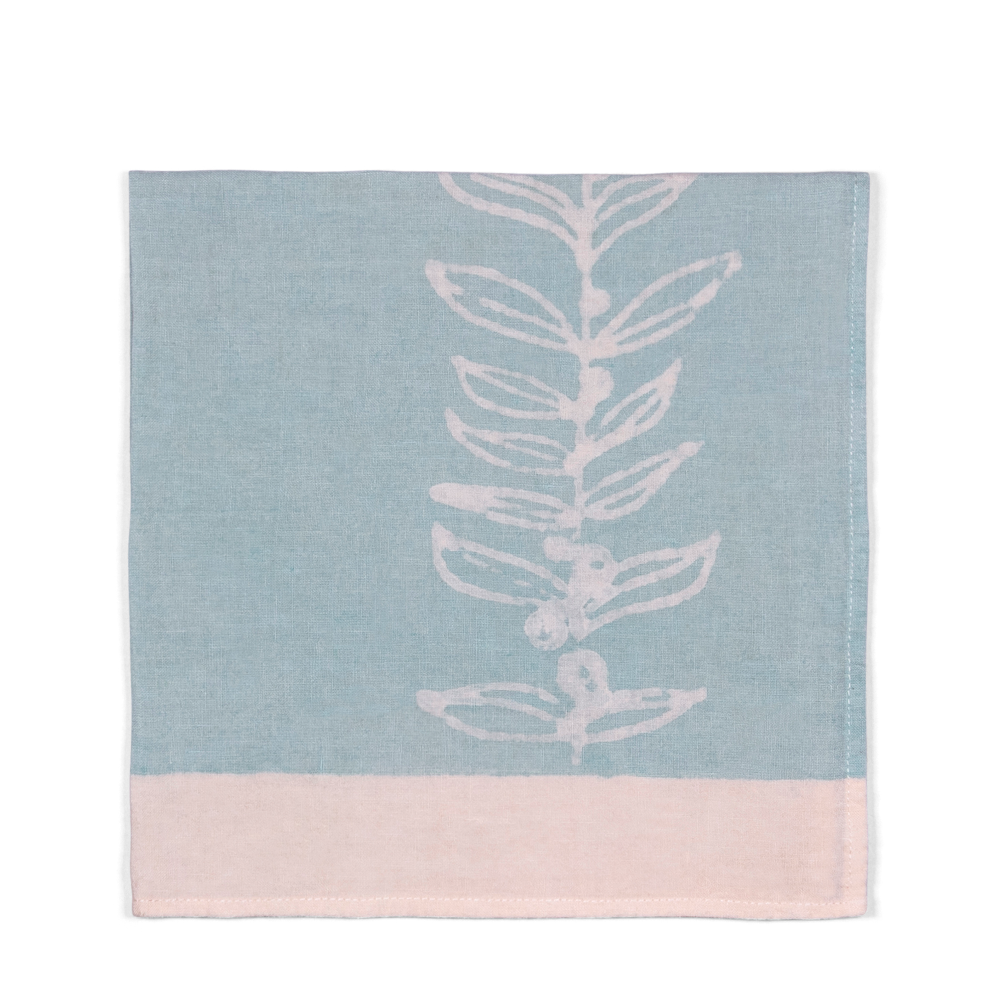 A 100% linen napkin in light blue and white border, with an illustration of a white tree. Perfect for breakfast, formal dining, or a garden tablescape.