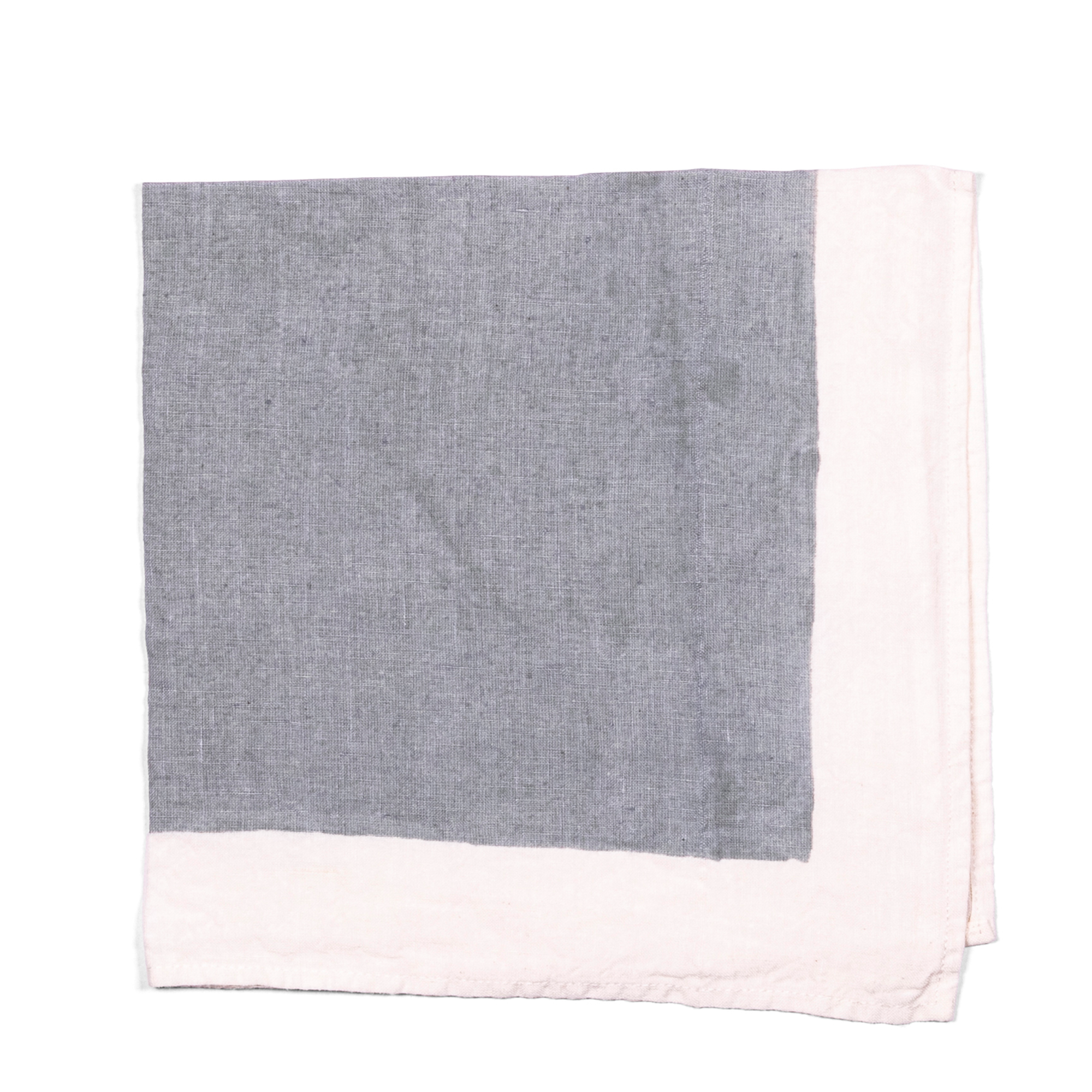 A stylish grey linen napkin with white borders, handmade using pear wood.  Can be used for breakfast, formal dining, or garden tablescape.