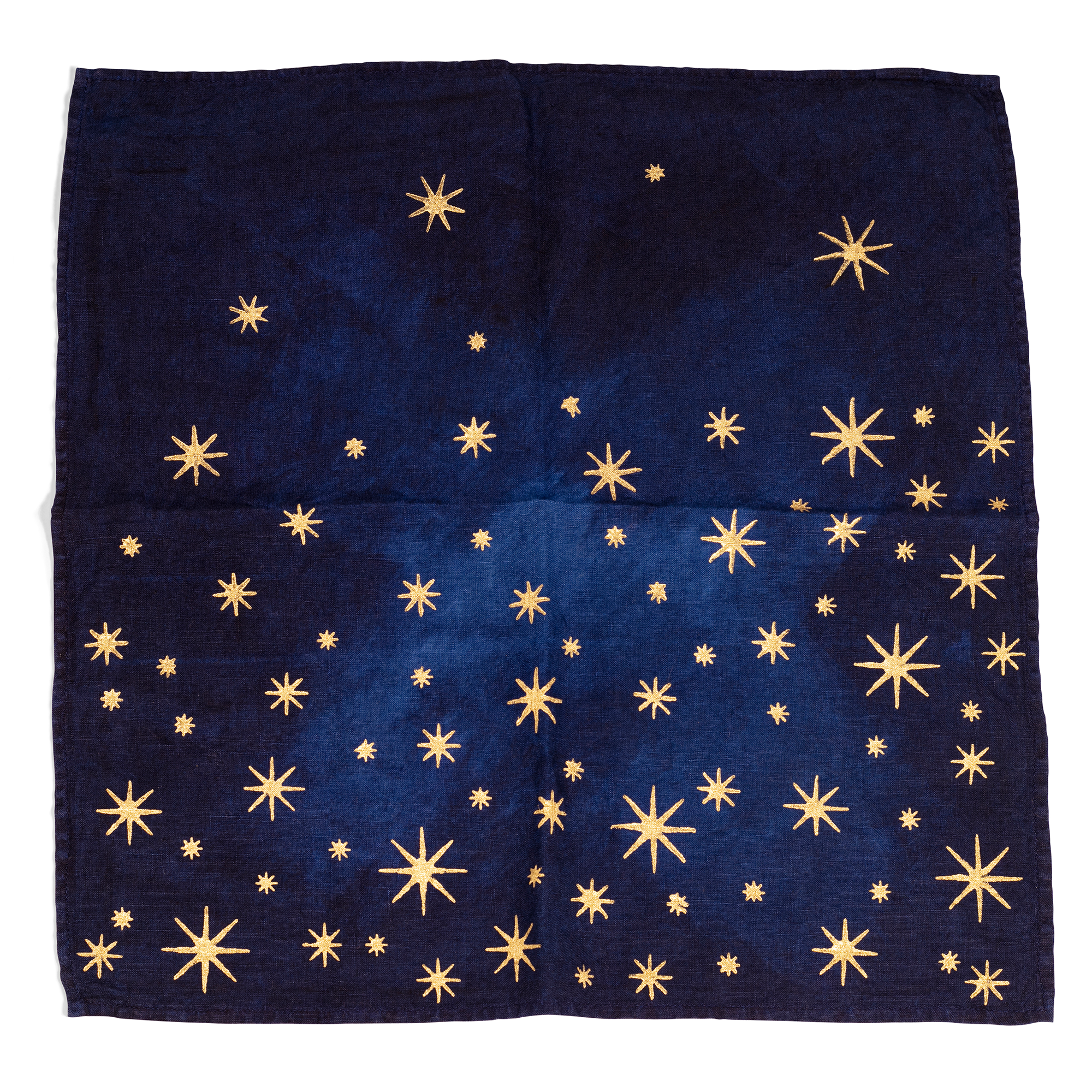 A luxurious indigo linen napkin with golden stars, perfect for adding a touch of elegance and contrast to any table setting.