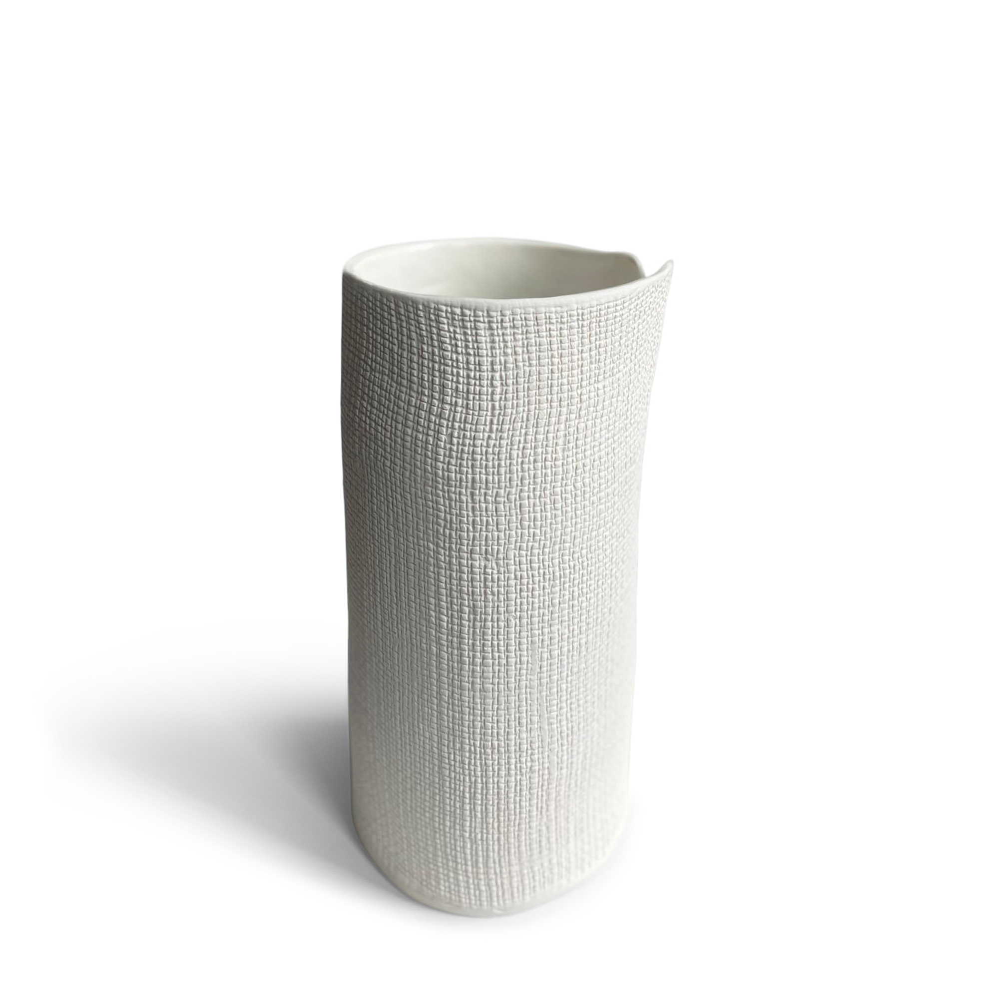 A textured white vase featuring a unique, cylindrical shape. The vase have a woven-like surface pattern that adds visual interest and a tactile feel. Its modern, sculptural design makes it perfect for minimalist or contemporary decor.