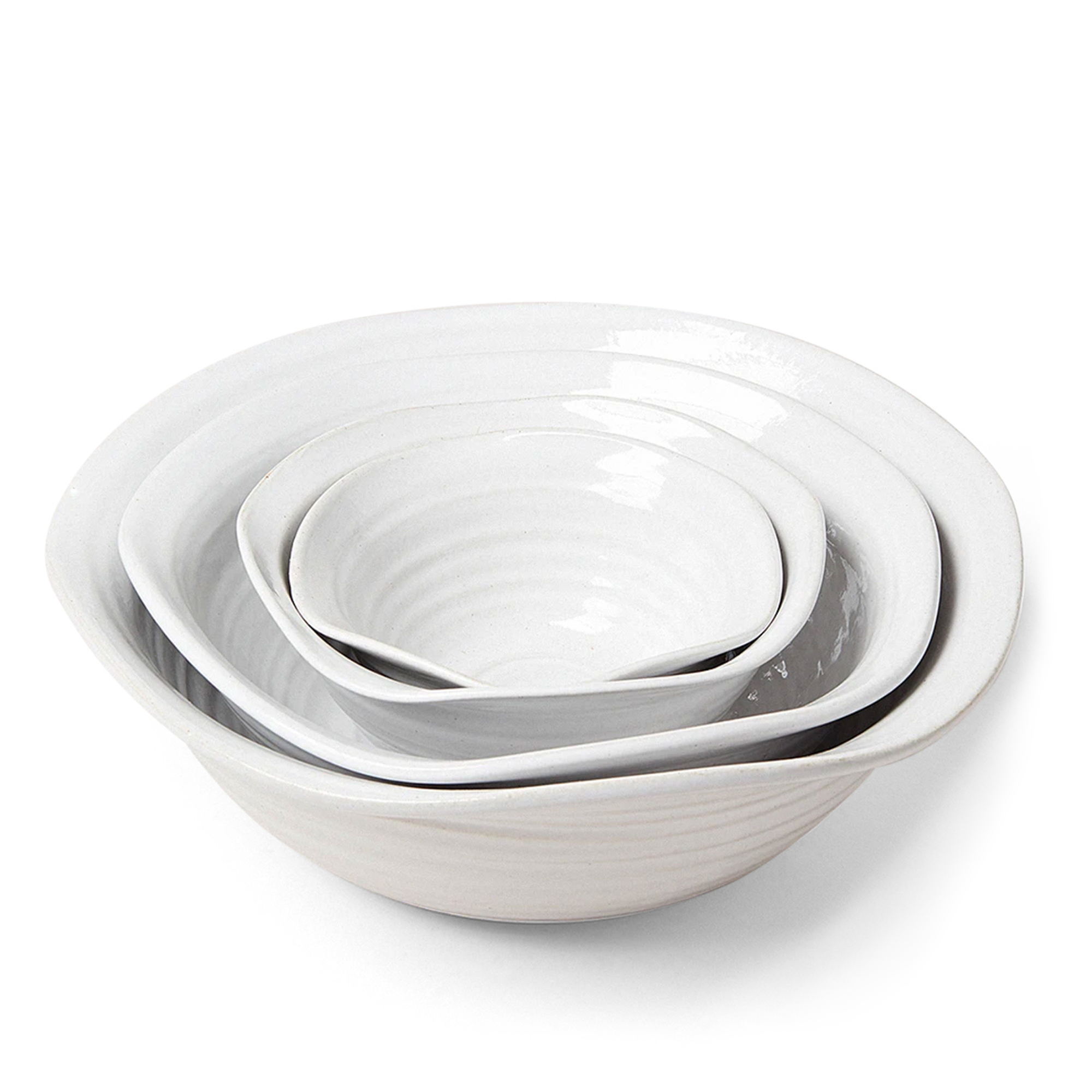 This handcrafted bowls reveal organic ridges and a delicately shaped rim. This versatile piece can serve as a large mixing bowl, a countertop accessory, or a beautiful centerpiece.