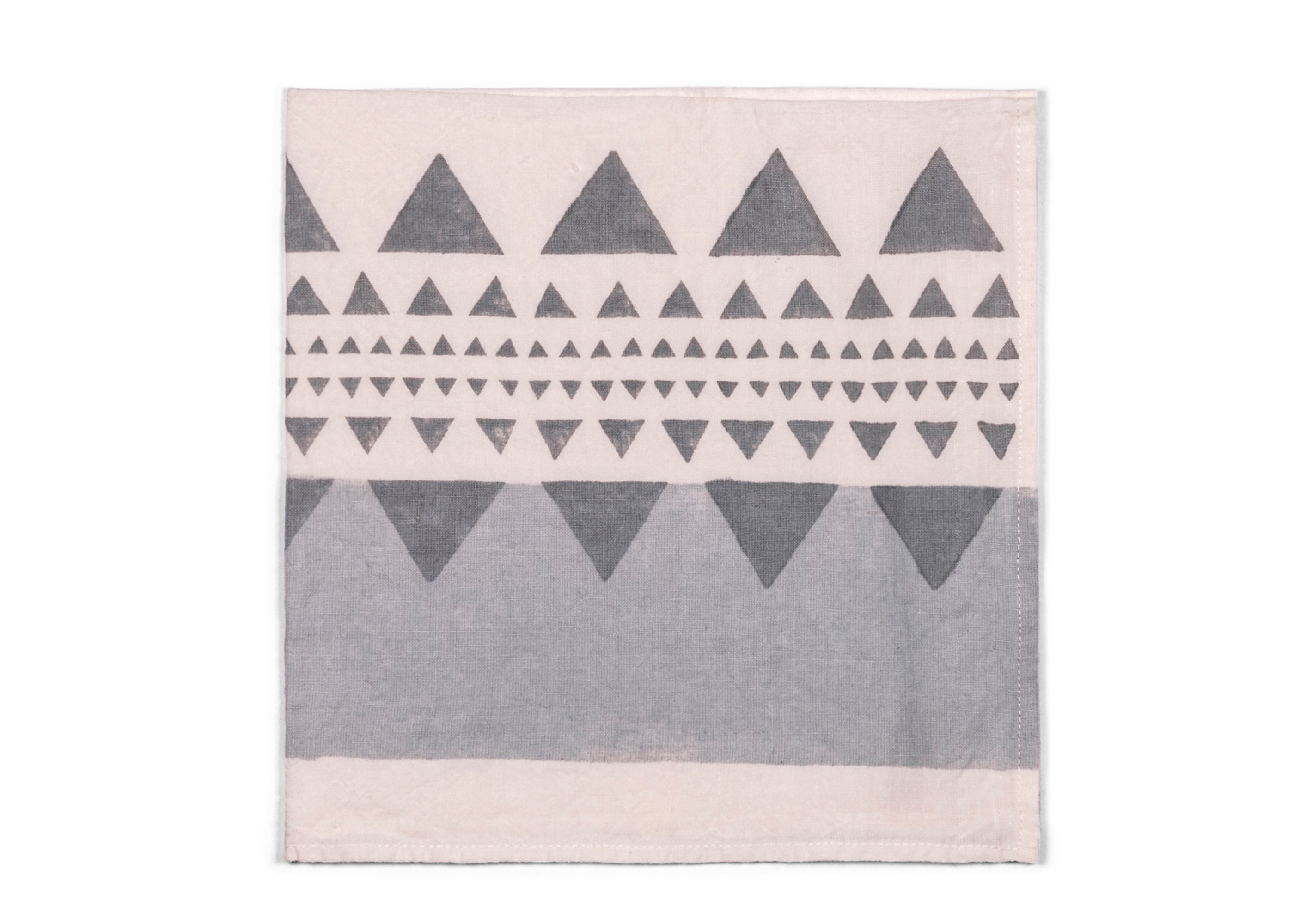 This napkin reveals a modern geometric pattern in shades of grey, accented with subtle touch of silver.