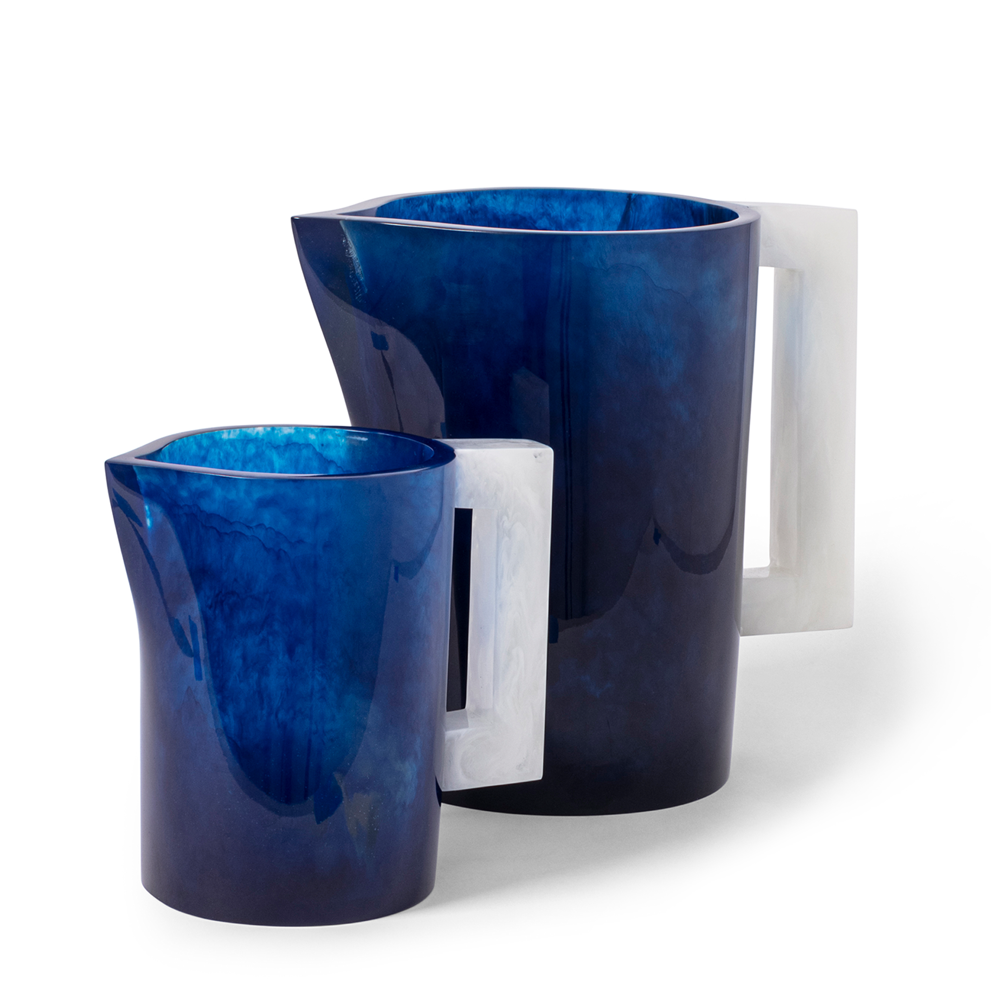 This Blue and White playful pitcher, with its delicately dispersed color that becomes more vibrant as light passes through, adds charm to your festive summer dinner party. Handcrafted using high-quality polymer resin from the Philippines.