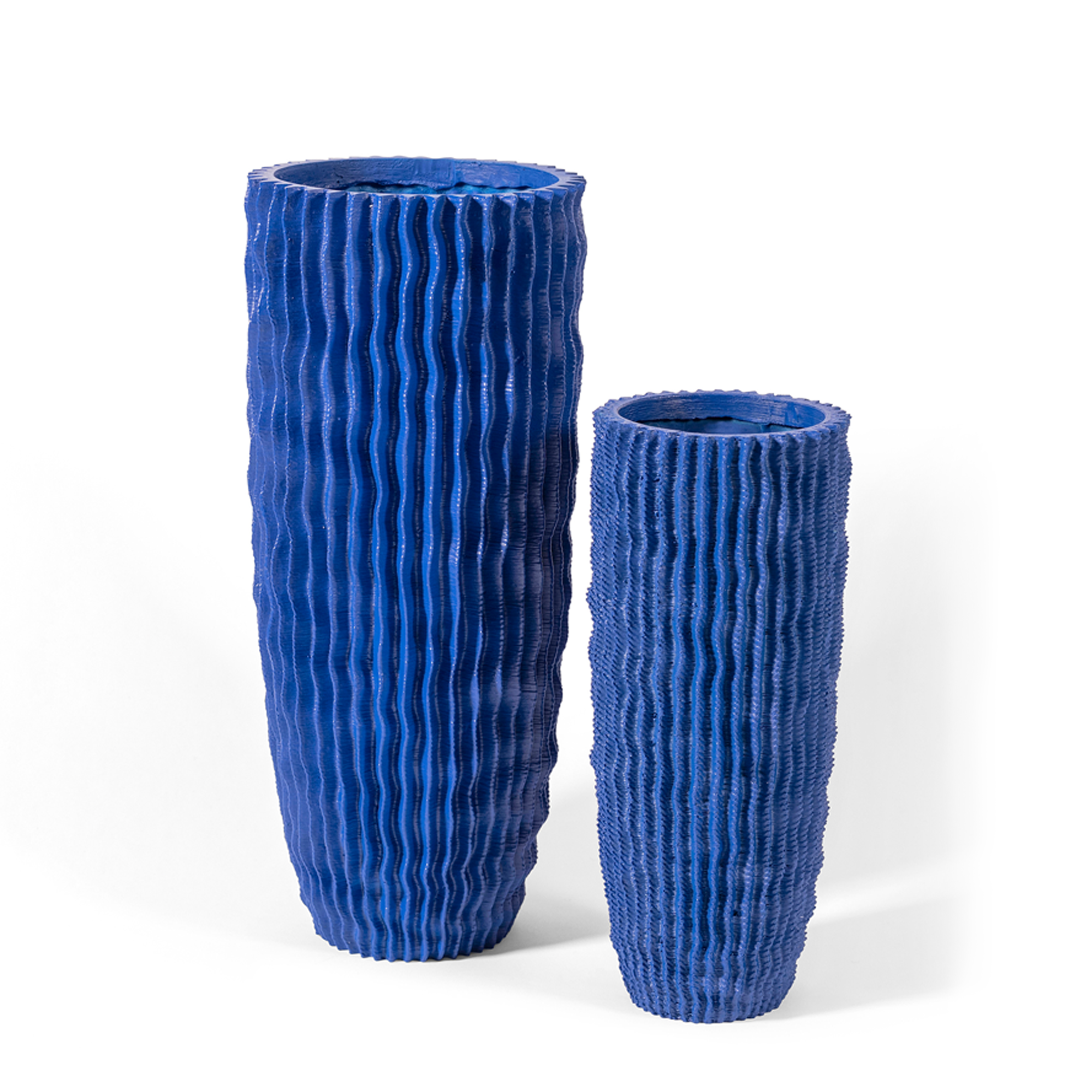 This textural cobalt Cactus Vase is intricately designed to emulate the ridges of a cactus, handcrafted of high-quality polymer resin with natural limestone sourced from the Philippines, offering both beauty and durability.