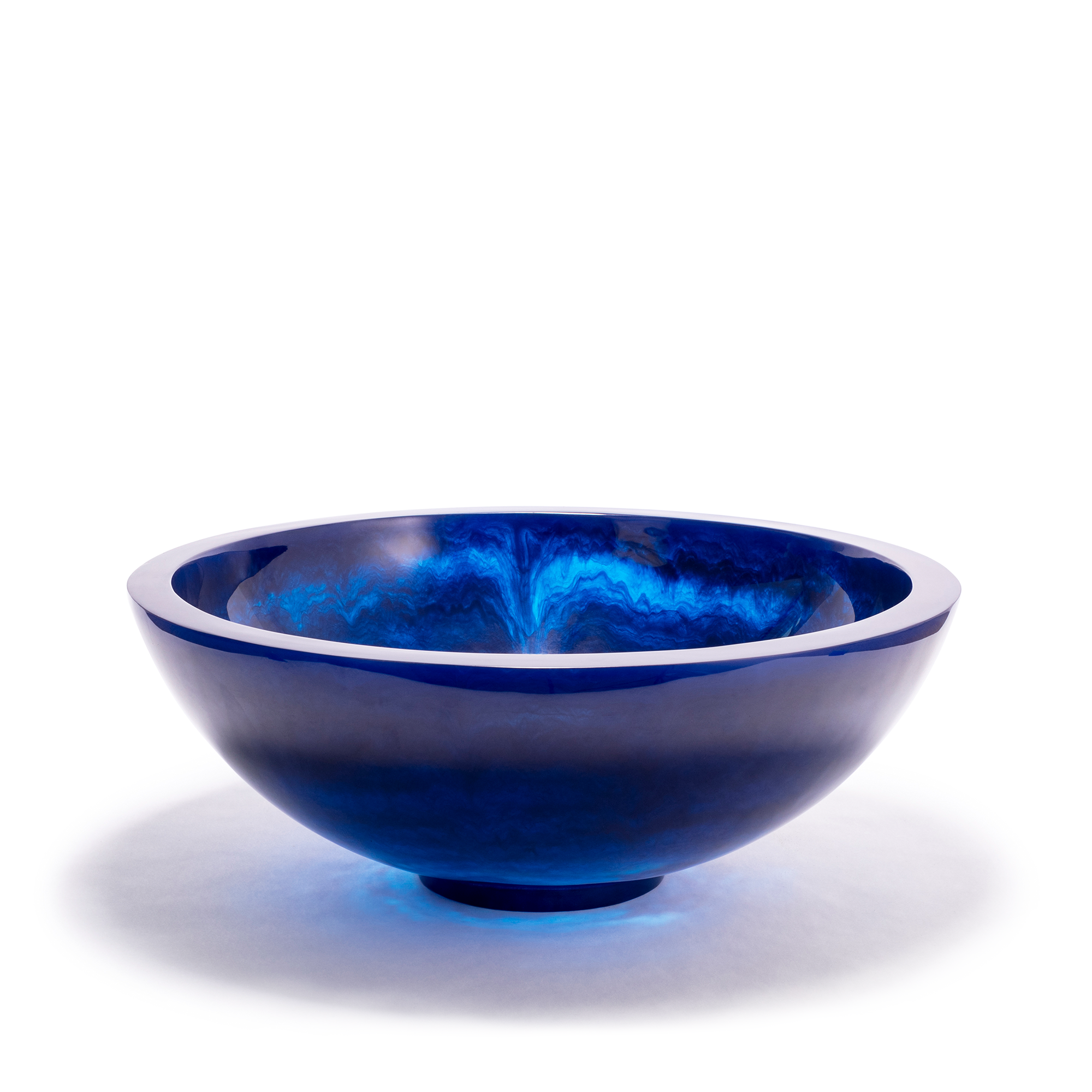 Large navy blue bowl with a smooth, glossy surface and an ethereal, cloud-like texture within the resin material, creating a captivating visual effect. The bowl has a rounded shape with a slightly elevated base.