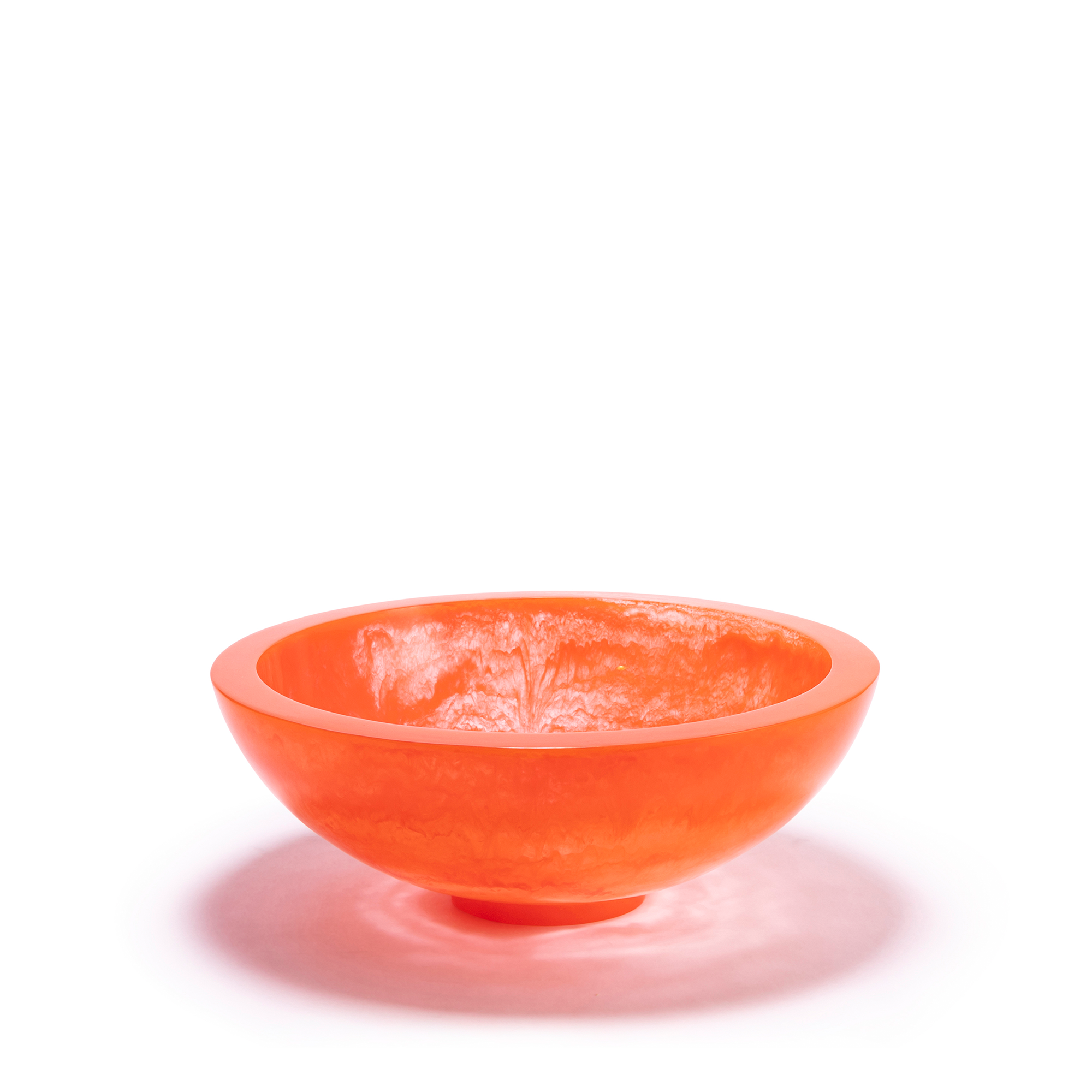 A sleek, orange bowl with a smooth, polished exterior and a subtle, luminous finish, featuring mesmerizing light refraction patterns within, reminiscent of molten lava. The bowl’s rounded, modern design and slightly elevated base make it a striking and contemporary centerpiece.