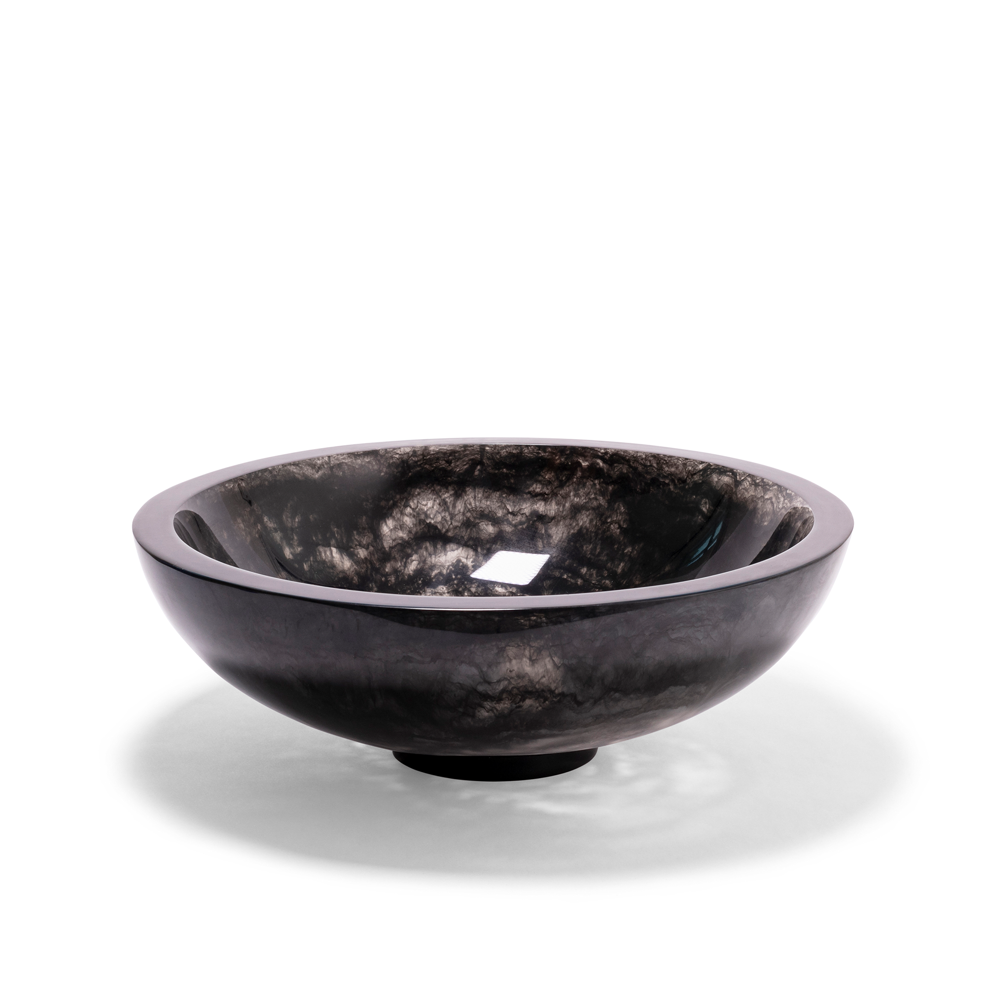 A sleek, black bowl with a smooth, polished exterior and a deep, reflective finish that contrasts with the textured, with a smoke swirling effect inside the bowl. The bowl has a rounded design with a slightly elevated base, creating a dramatic centerpiece for any contemporary decor.